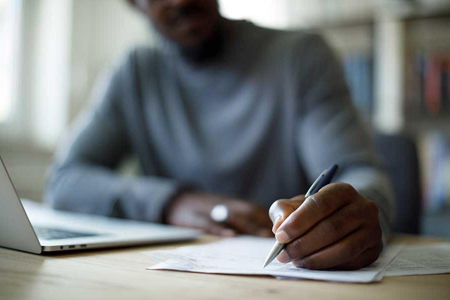 Person writing on paper